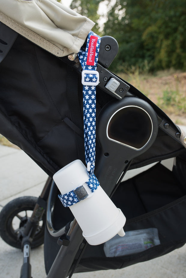 Toddler sippy cup attached to a stroller to keep it from dropping. BooginHead SippiGrip in Stars