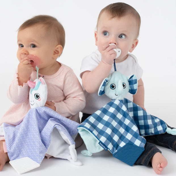 Babies each with their favorite lovey, Dreamer the Unicorn and Lucky the Elephant, both keeping track of their pacifiers with the handy loop. Purple and white unicorn and blue and white elephant.