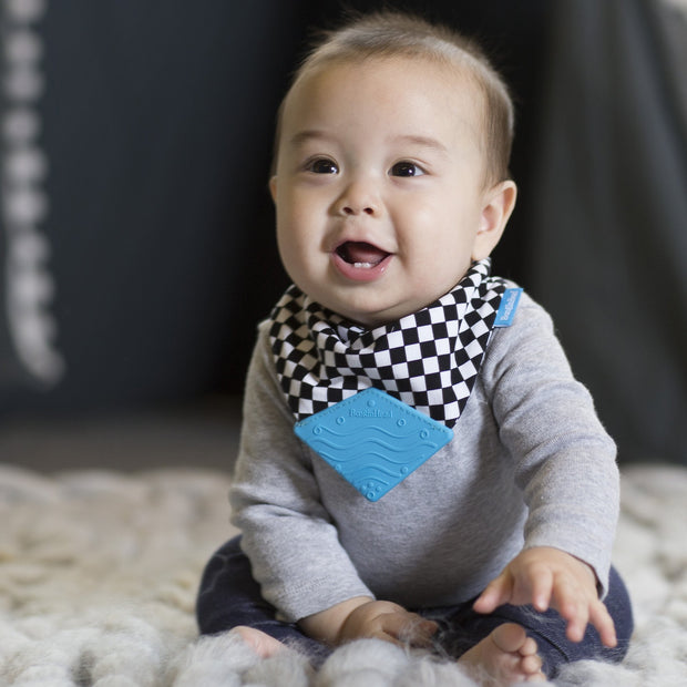 Baby boy wearing BooginHead Bandana Teether Bib in Checkerboard for drool protection vans design
