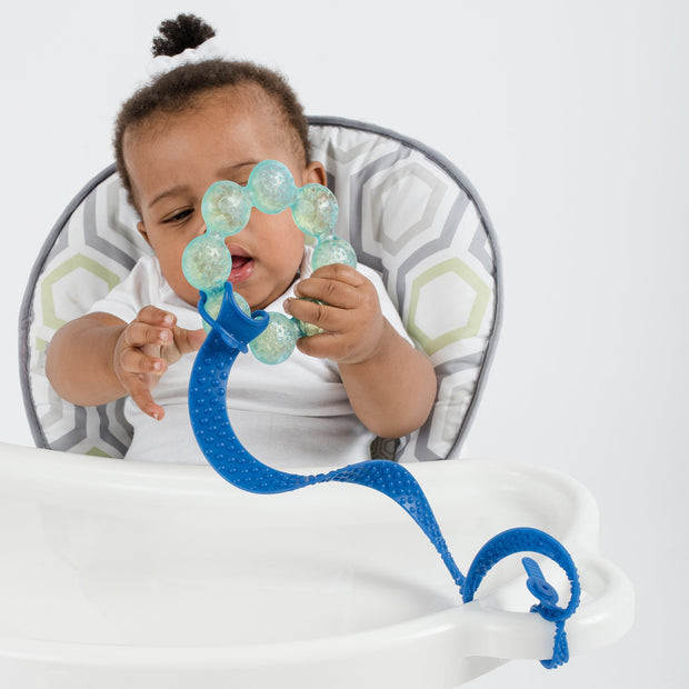 Toddler using BooginHead SippiGrip Silicone sippy cup strap in Royal Blue. Hold sippy cups, bottles and toys to high chairs and strollers