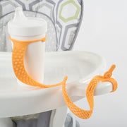 BooginHead SippiGrip Silicone in Creamsicle Orange, strap to hold a sippy cup, bottle or toy, with soothing teething bumps. Attaches to high chair or stroller to prevent dropping