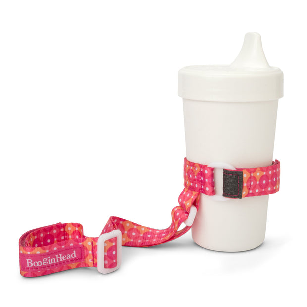 BooginHead SippiGrip in Dottie keeps sippy cup from falling on the ground getting dirty or lost. Keeps baby items off the ground and clean. Bright pink with orange and white polka dot design 