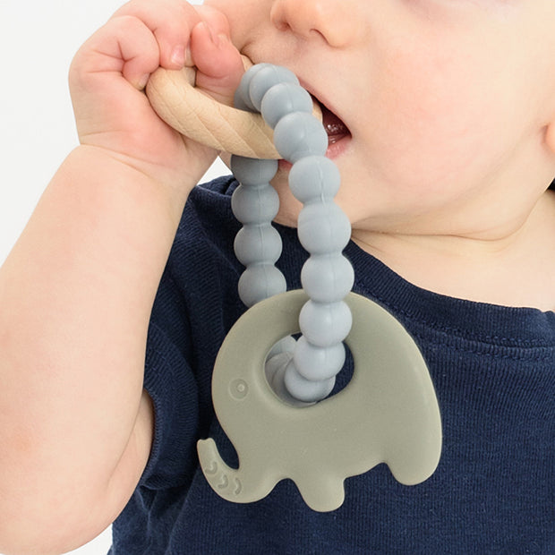 Baby using BooginHead silicone & wood teether, gray elephant